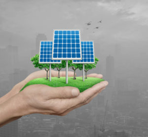 Solar panels in man hands over polluted city