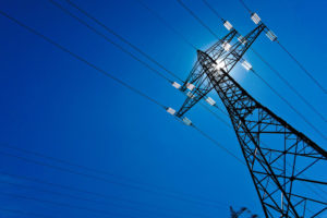 Electricity pylon with sun and sky