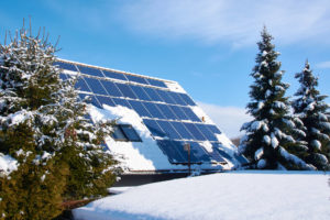 Solar panel with snow and blue sky