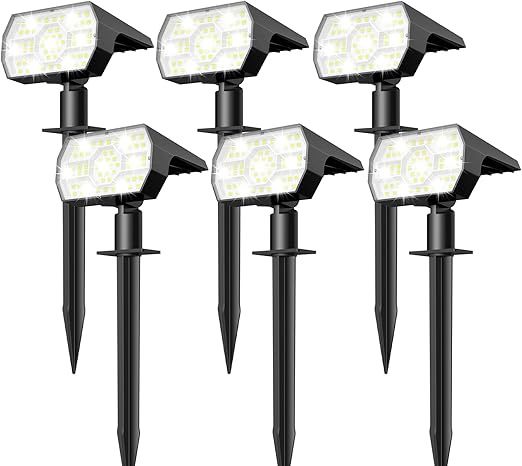 Solar pathway stake lights in a garden border